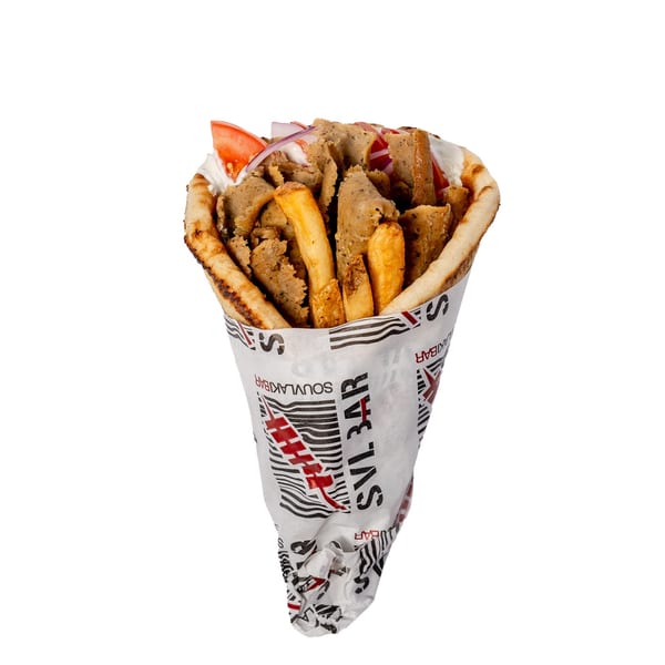 A gyros pita wrap, filled with meat, fries, tomatoes, and onions, wrapped in branded paper.